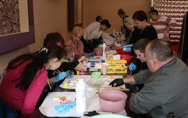 Dziadkowie z wnuczkami podczas warsztat&oacute;w rękodzieła. 